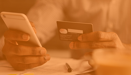 Hand holding a smartphone and card